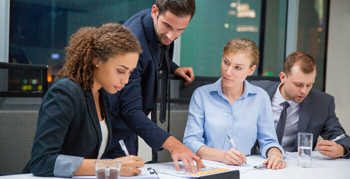 elegant-man-suit-showing-two-partners-paper